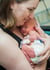 Mom cradles newborn in NICU